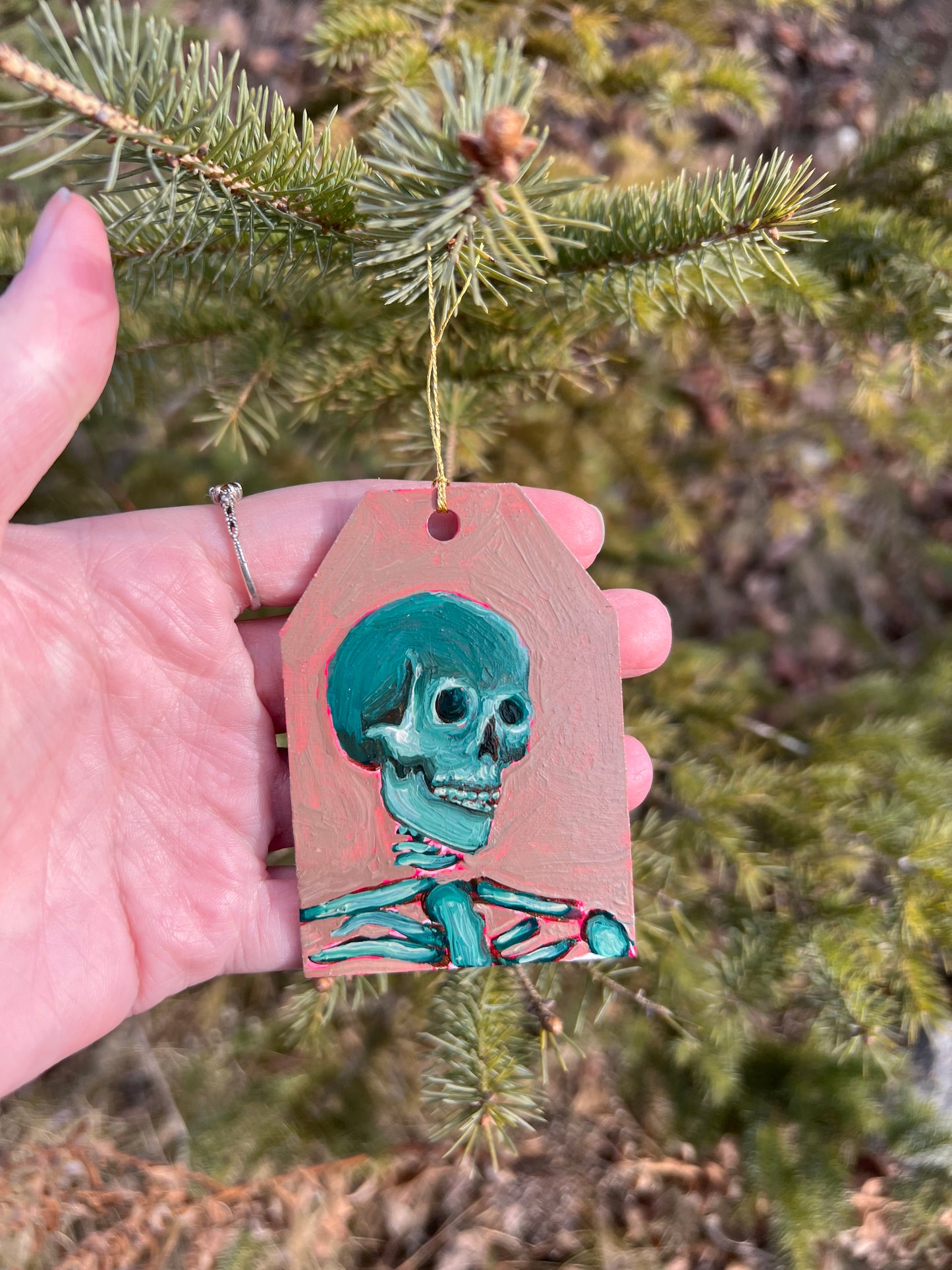 Beige and forest green skeleton ornament